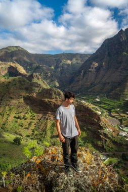 Young man contemplates the landscape. Agaete Valley. Gran Canaria. Canary Islands clipart