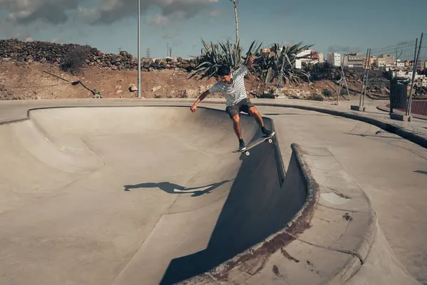 stock image young man skating a a skate park in a sunny day