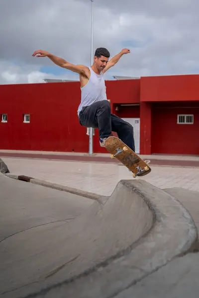 stock image young man skater jumping a ramp in a skate park. vertical composition