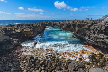 rocky beach with a natural arch in Las Puntas. El Hierro island. Canary Islands