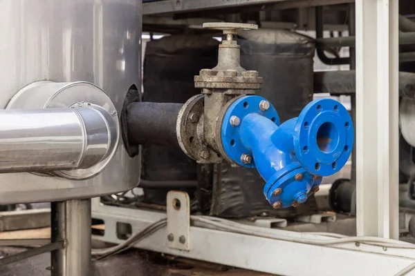 Handwheel type blue metal valve and pipes, industrial equipment at wine factory, close up, copy space