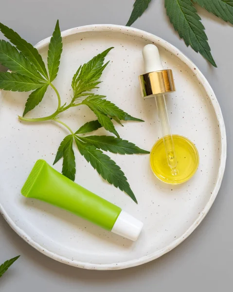 Cream Tube Pipette Green Cannabis Sativa Leaves Plate Grey Table — Stock Photo, Image