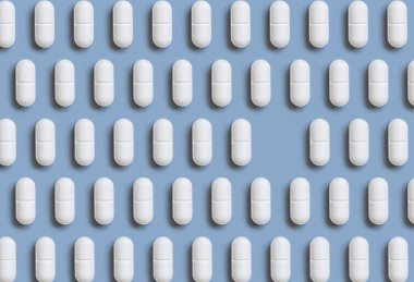 Açık mavi üst görüşlü beyaz haplar, tek bir boş yeri olan yaratıcı desen. Tedavi edici ilaçlar ve sağlık hizmetleri, diyet takviyeleri ve vitaminler. İlaç hapları.