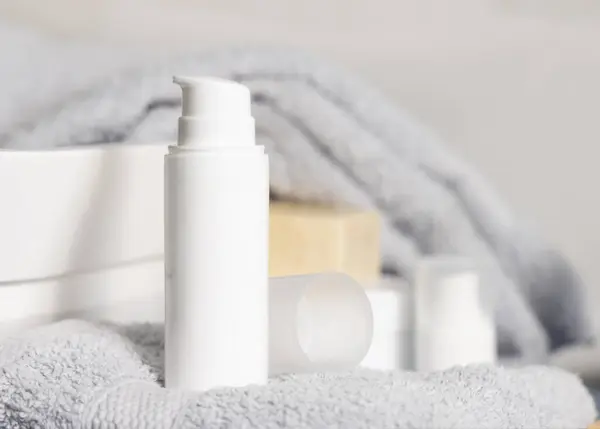 White One Pump Cosmetic Bottles Grey Folded Towel Basin Bathroom 图库图片