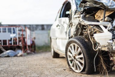 Front of silver car get hard damaged by accident on the road. Maintenance or car repair concept