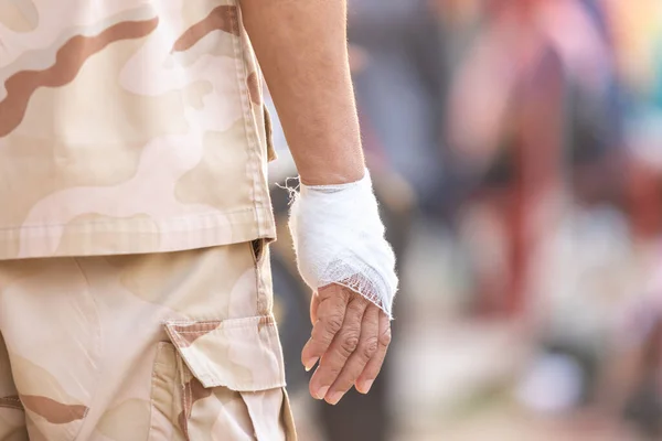 Hand injury : Close up soldier\'s hand and wrapped with white bandages