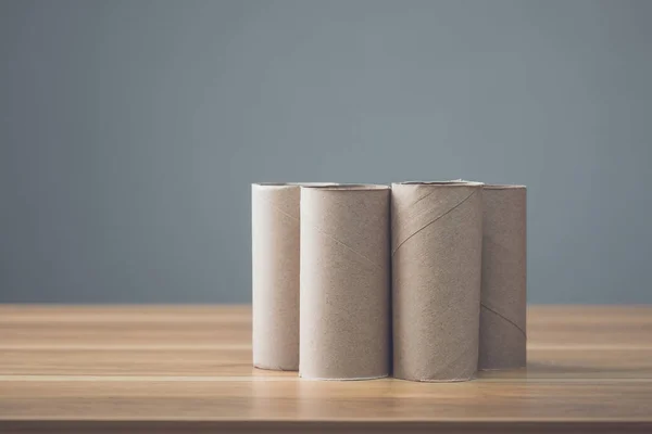 Pile Brown Paper Tissue Cores Wooden Table Grey Wall Background — Stock Photo, Image