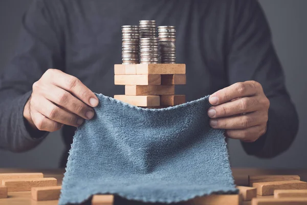 stock image Hidden about risks in business or financial. Idea to keep risky as secret. Businessman using cloth to cover over tower wooden block stacking game on wooden desk in office. Studio shot.