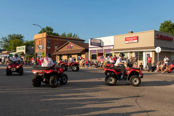 stock image Battle Lake, Minnesota USA July 23, 2022 Parade in Battle Lake, Minnesota for Wenonga Days celebration. Four wheelers, all-terrain vehicles doing fancy driving in the parade.