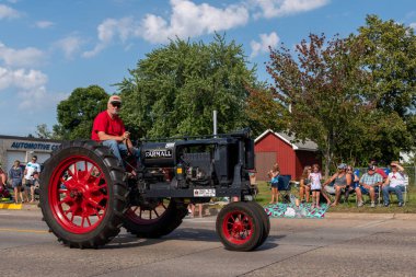 Mora, Minnesota USA July 30, 2022  Parade in Mora, Minnesota for the Kanabec County Fair. Tractor in the parade. clipart