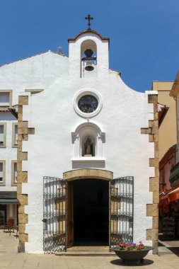 The cute small white church called the Chapel of Our Lady of Socorro in Tossa de Mar, Costa Brava, Spain.