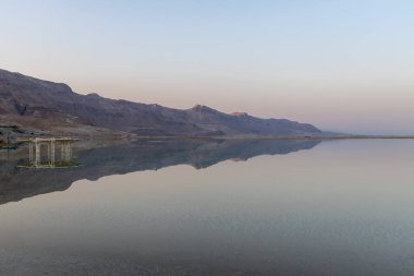 The beautiful Judean desert mountains reflected in the Dead Sea at Ein Bokek, Israel.