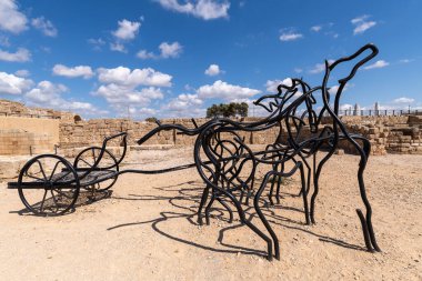 Bir zamanlar Caesarea, Caesarea 'daki hipodromda yapılan yarışların anısına şekillendirilmiş siyah metal tüplerden yapılmış at ve at arabası heykeli şimdi İsrail' deki Caesarea Ulusal Parkı 'nda..