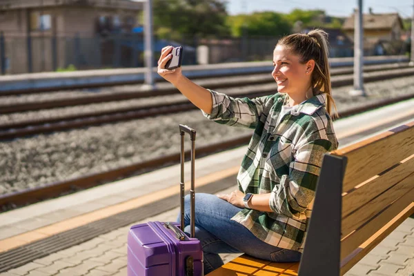 Счастливая Женщина Делает Селфи Мобильным Телефоном Сидя Вокзале — стоковое фото
