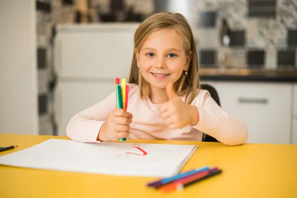 Beautiful Little Girl Showing Thumb While Enjoys Drawing Her Home — Stock Photo, Image
