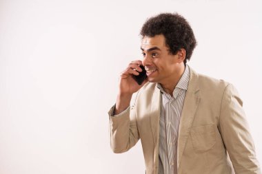 Image of excited businessman talking on the phone.