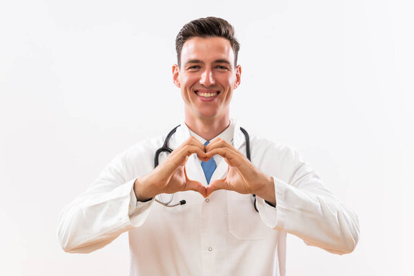 Portrait of doctor showing heart shape with hands.
