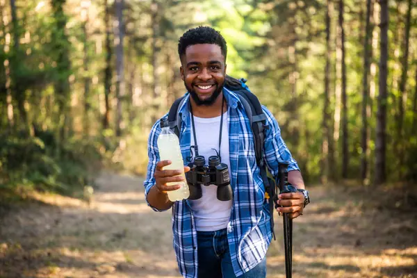 Young Man Enjoys Hiking Drinking Energy Drink Stockbild