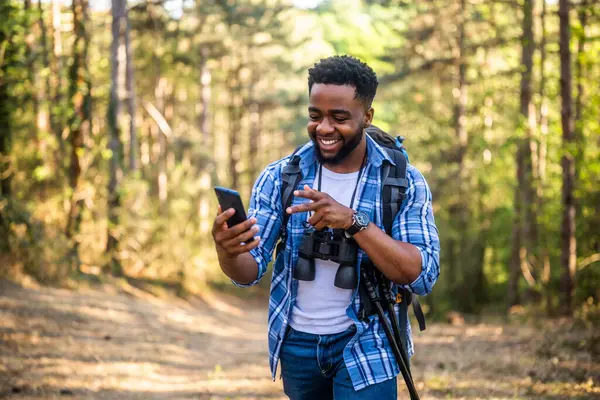 Young Man Enjoys Hiking Using Mobile Phone Nature Stockbild