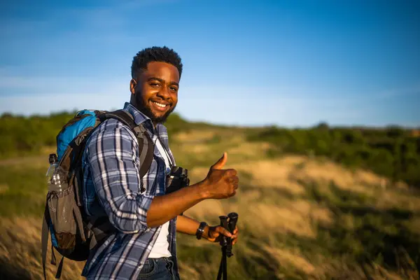 Portrait Young Man Enjoys Hiking Nature Showing Thumb Stockbild