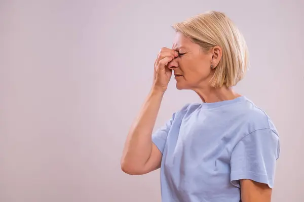 stock image Mature woman is having pain in sinus.