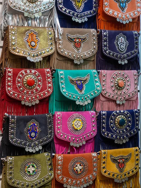 Colorful Moroccan artisan bags exposed in the street of a shop in Marrakech Morocco