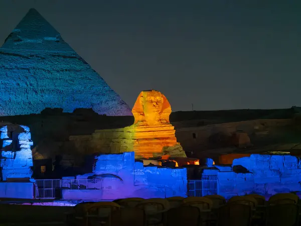 stock image Panoramic view of Illumination of the great Sphinx of Giza next to the Pyramid of Kefren during the night light show in El Cairo Egypt