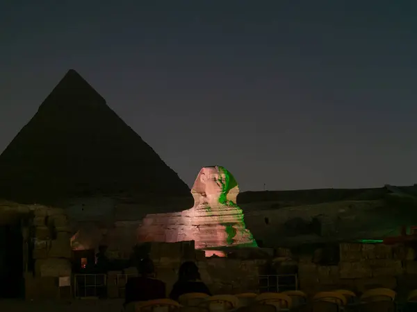 stock image Panoramic view of Illumination of the great Sphinx of Giza next to the Pyramid of Kefren during the night light show in El Cairo Egypt