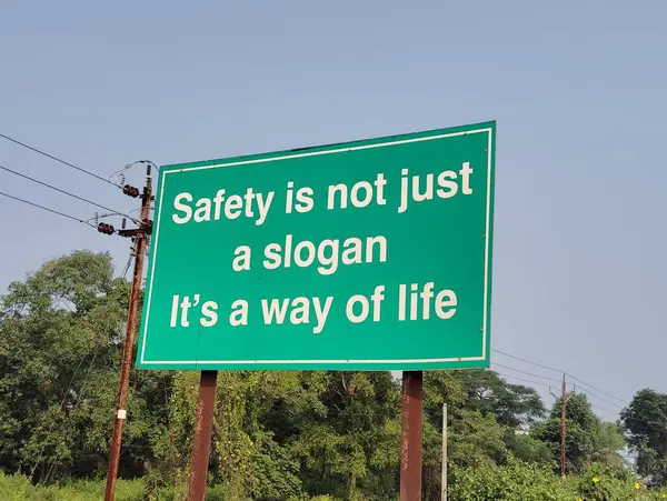 Safety is not just a slogan it\'s a way of line sign board on the road side.