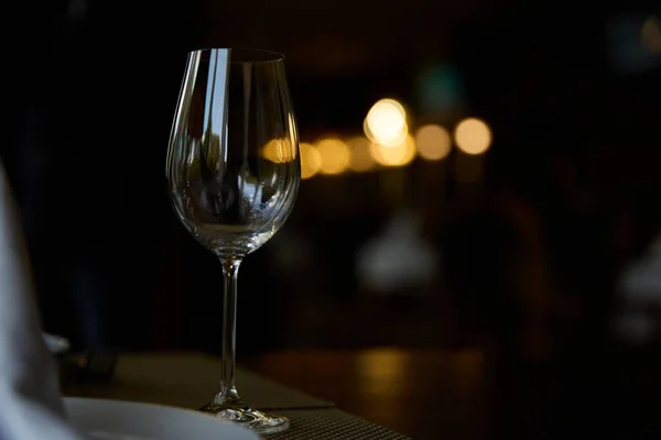 stock image An empty glass of wine on a table in a restaurant. Isolated. High quality photo