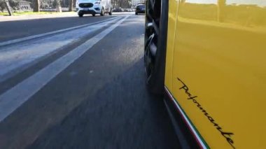 ROME, ITALY - NOVEMBER 7, 2022: Exclusive Lamborghini driving in traffic time, sports car close up details in motion across the streets of ancient Rome, luxury Lamborghini exterior. High quality 4k