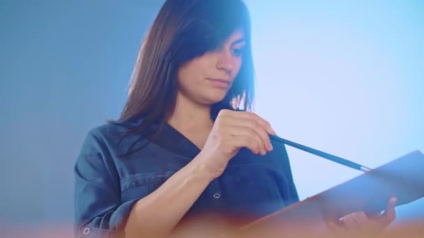 Talented Female Artist Workshop Dark Blue Illuminated Background Concentrated Woman — Video