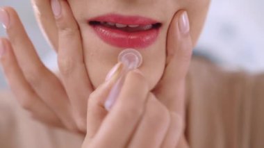 Woman using silicone cup for doing facial massage at home, female cupping around mouth cavity to smooth deep aging wrinkles and improve blood circulation, facial vacuum massage and beauty rejuvenation