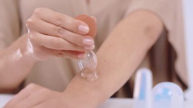 Procedure of vacuum massage with silicone cupping for improving blood circulation, female cupping arm to smooth wrinkled skin, hydration, regeneration and rejuvenation of skin with special cosmetology