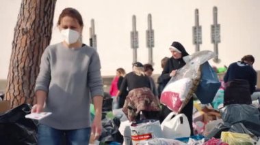 ROME, ITALY - MARCH 10, 2022: Ukrainian diaspora in Rome gathering, sorting and packaging humanitarian aid for Ukrainian nation during the war, people preparing basic necessities in the yard of St
