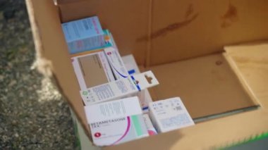 ROME, ITALY - MARCH 10, 2022: Collected medicine in carton box for supporting Ukrainian people during the first months of the war, painkillers, antibiotics, anti-inflammatory preparations for saving