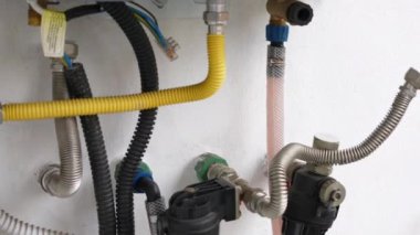 Repairing and maintenance of gas water heater pipes because of excessive calcium scale and sediment, plumbing tank with hot acid solution circulating through the home pipes to remove water stones and