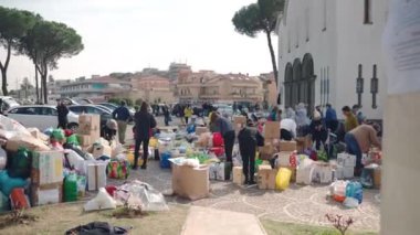 ROME, ITALY - MARCH 10, 2022: Volunteers collection humanitarian aid in the front yard of St. Sophia Church in Rome, activists sorting and packaging basic necessities for refugees and war victims in