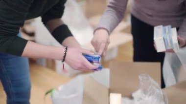 ROME, ITALY - MARCH 10, 2022: Ukrainian diaspora in Rome gathering, sorting and packaging medicine boxes for delivering in Ukraine, necessary medicine for saving life of civilian and military people