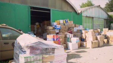 ROME, ITALY - MARCH 10, 2022: Carton boxes with humanitarian aid for Ukrainians in central warehouse of Rome, basic necessities like food, clothes, medicine prepared to be delivered to Ukrainian