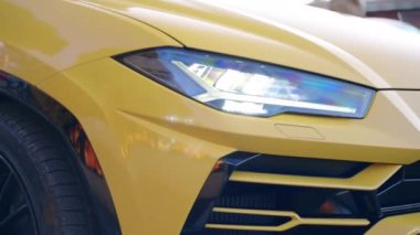 ROME, ITALY - NOVEMBER 7, 2022: LED front headlights of exclusive Lamborghini sports car, premium class car design, performance on the streets of Rome. High quality 4k footage