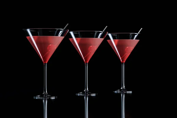 stock image Cosmopolitan cocktails with cherry in martini glass