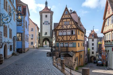 Polnlein in historic old town of Rothenburg ob der Tauber, Germany. Old historic houses and gate towers. clipart