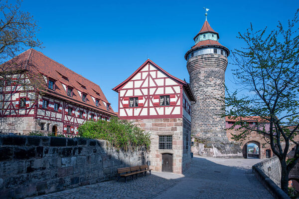 Yard of  Castle of Nuremberg with half-timbered houses and tower in Nuremberg, Germany. Historic old town.