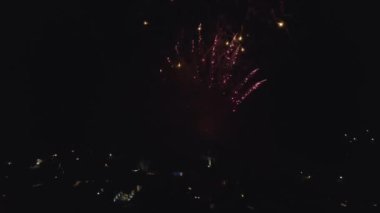 Fireworks in the City Sky. Aerial Drone Scene. City Night Lights. The Camera Rotates in a Semicircle and it is seen how the fireworks explode. Amazing work