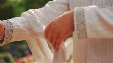Inside the Indian wedding, the bridegroom brides together and worships the Lord. Happy indian groom wearing white traditional clothes, beautiful portrait