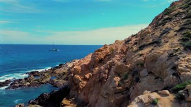 Pasifik Okyanusu 'nun derin mavi sularıyla buluşan kayalık kıyı şeridinin sakin manzarası Cabo San Lucas, Meksika' da. Sahilin engebeli güzelliklerini keşfetmek için mükemmel bir doğal ortam..