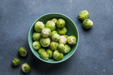 Raw Organic Brussel Sprouts in a Bowl, top view. Flat lay, overhead, from above. Copy space.