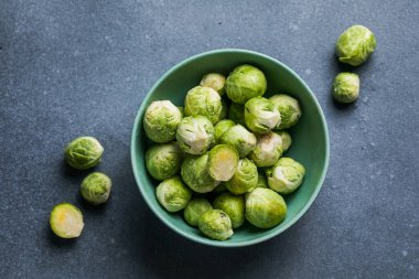 Raw Organic Brussel Sprouts in a Bowl, top view. Flat lay, overhead, from above. Copy space.