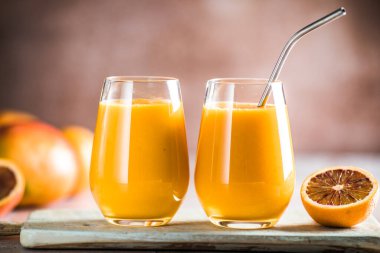 İki mango lassi ya da bardakta kesar süt. Hint sağIıklı ve mangolu soğuk bir içecek. Taze Lassi yoğurttan, sudan, baharatlardan, meyvelerden ve buzdan yapılır..